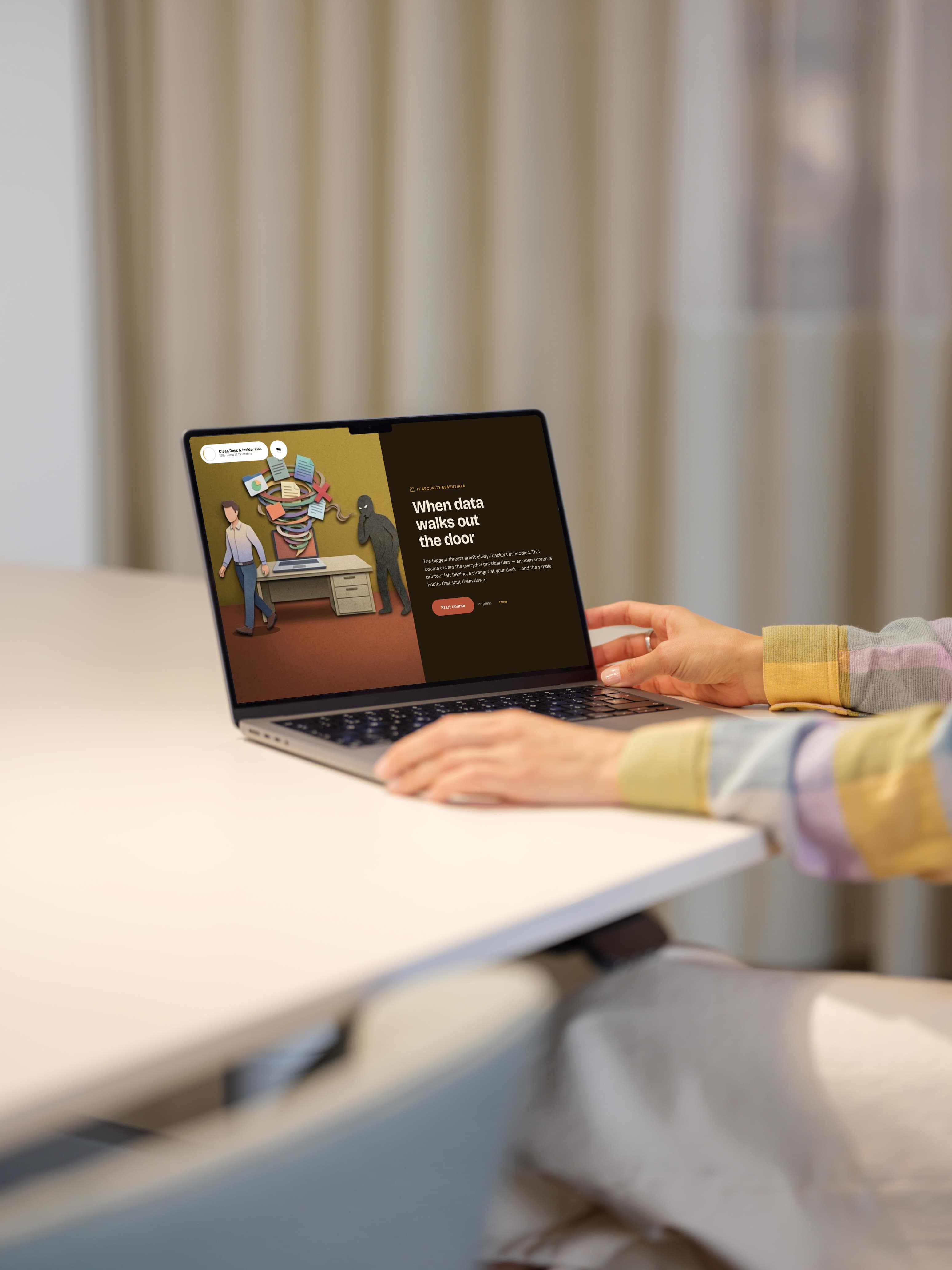A learner taking a Saga course on a laptop — an illustrated IT-security lesson, 'When data walks out the door'