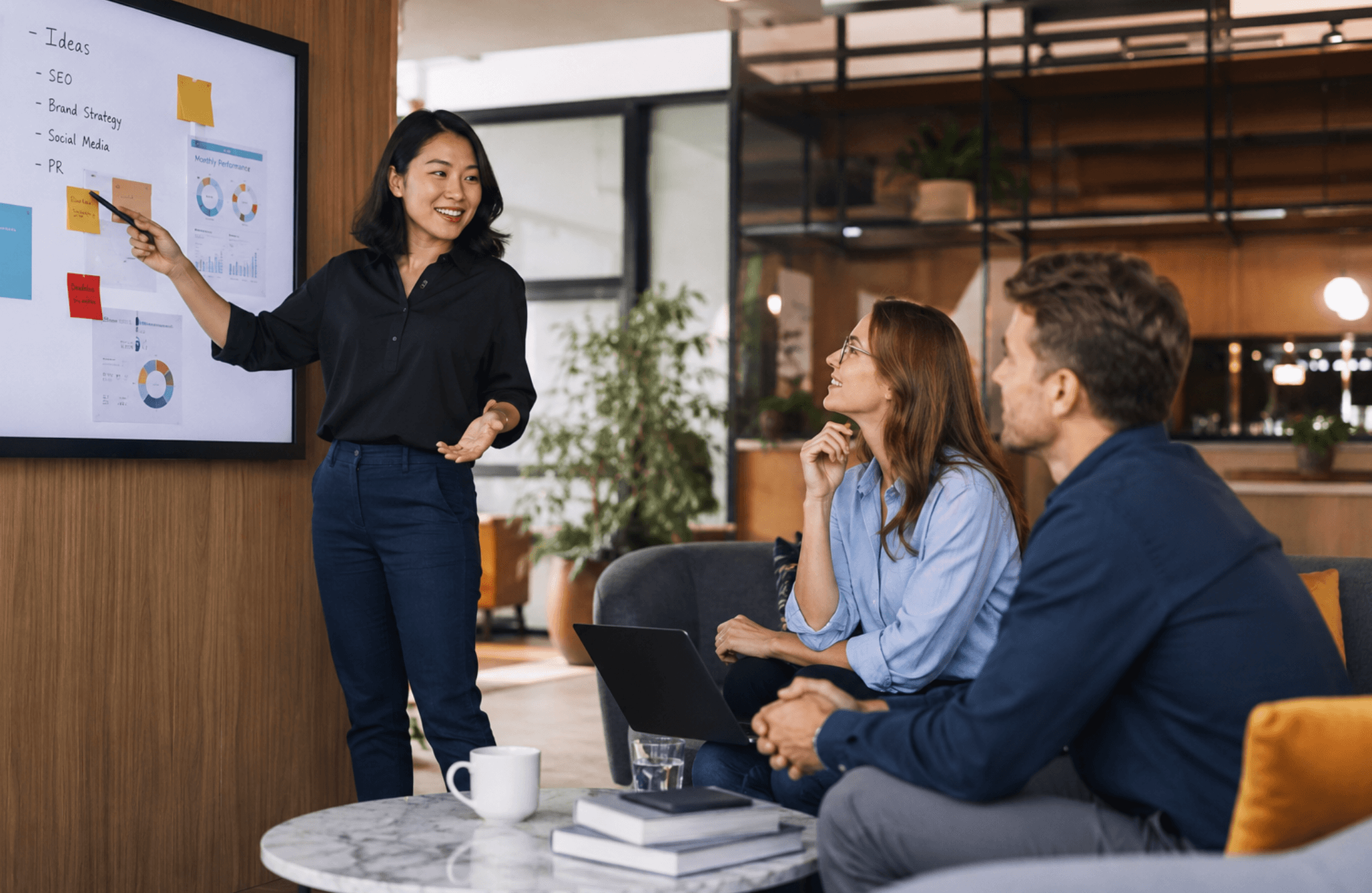 Employee presenting workplace training ideas to colleagues during a team meeting in a modern office.
