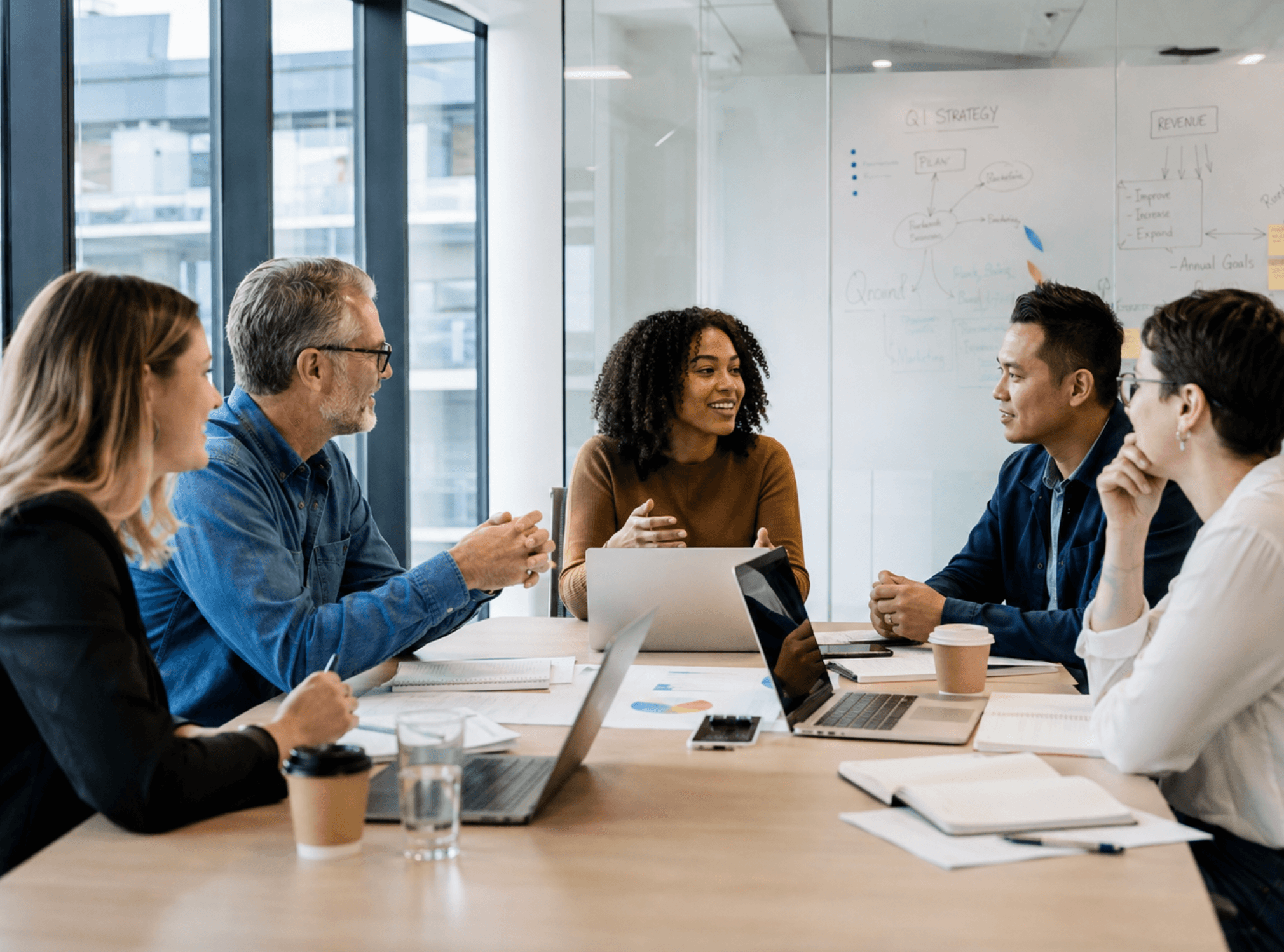 Team collaborating during a business meeting in a modern office.